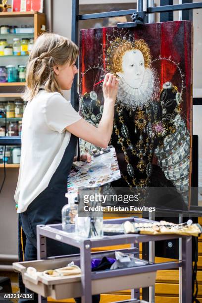 Conservator is pictured in front of portraits of Elizabeth I and Sir Amias Paulet at Hamilton Kerr Institute as they are prepared for exhibition on...