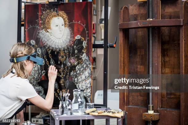 Conservator is pictured in front of portraits of Elizabeth I and Sir Amias Paulet at Hamilton Kerr Institute as they are prepared for exhibition on...