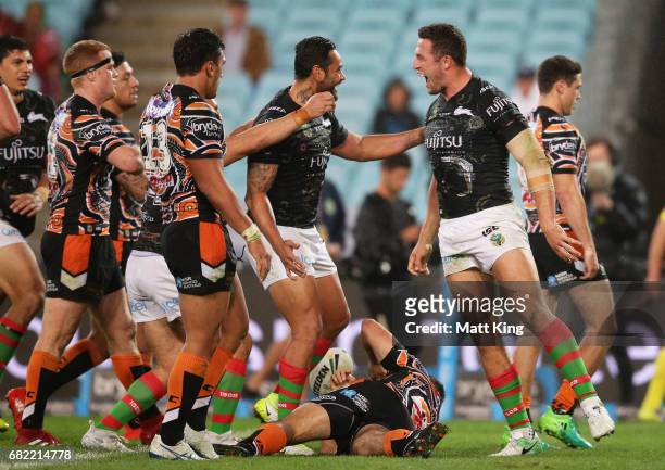Sam Burgess of the Rabbitohs celebrates with team mates after scoring a try during the round ten NRL match between the Wests Tigers and the South...