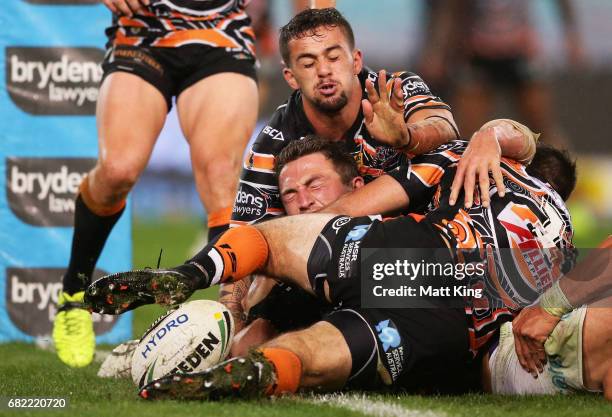 Sam Burgess of the Rabbitohs reaches out to score his second try during the round ten NRL match between the Wests Tigers and the South Sydney...