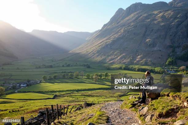 sunlit valley and hillwalker; english lake district, u.k - english lake district 個照片及圖片檔