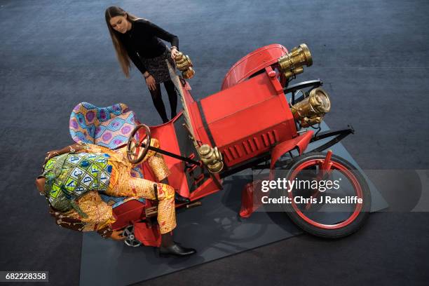 Sotheby's employee poses next to Crash Willy by Yinka Shonibare MBE, estimated at £120,000 - £180 during a press call for an inaugural sale of modern...