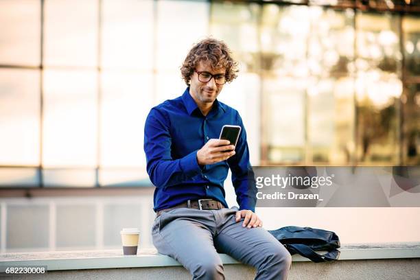man using smart phone for internet browsing - effortless experience stock pictures, royalty-free photos & images