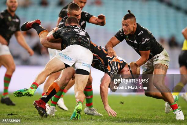 Joel Edwards of the Tigers is tackled during the round ten NRL match between the Wests Tigers and the South Sydney Rabbitohs at ANZ Stadium on May...