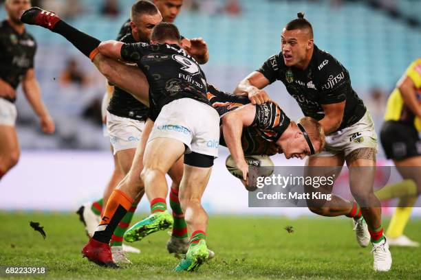 Joel Edwards of the Tigers is tackled during the round ten NRL match between the Wests Tigers and the South Sydney Rabbitohs at ANZ Stadium on May...