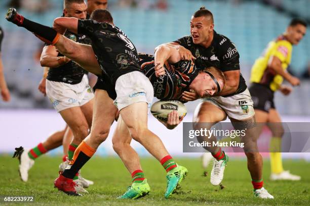 Joel Edwards of the Tigers is tackled during the round ten NRL match between the Wests Tigers and the South Sydney Rabbitohs at ANZ Stadium on May...