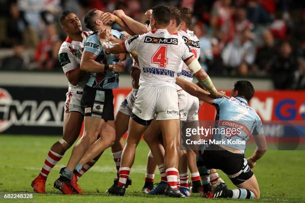 Players scuffle during the round 10 NRL match between the St George Illawarra Dragons and the Cronulla Sharks at UOW Jubilee Oval on May 12, 2017 in...