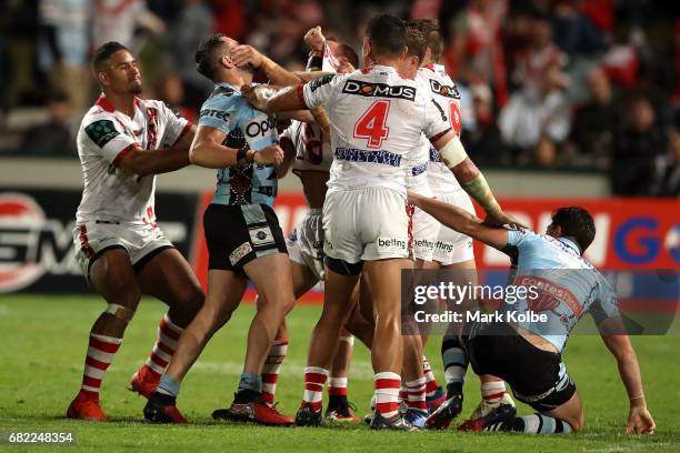 Players scuffle during the round 10 NRL match between the St George Illawarra Dragons and the Cronulla Sharks at UOW Jubilee Oval on May 12, 2017 in...