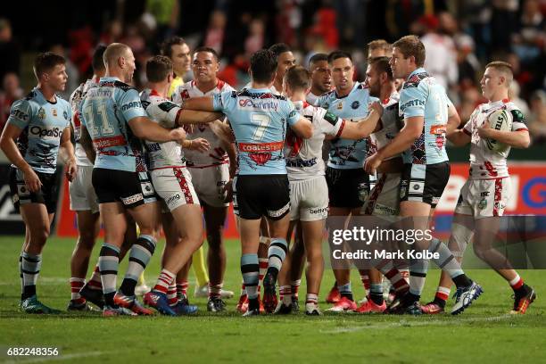 Players scuffle during the round 10 NRL match between the St George Illawarra Dragons and the Cronulla Sharks at UOW Jubilee Oval on May 12, 2017 in...