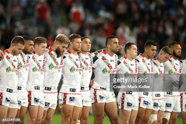 The Dragons stand for the national anthem during the round 10 NRL match between the St George Illawarra Dragons and the Cronulla Sharks at UOW...