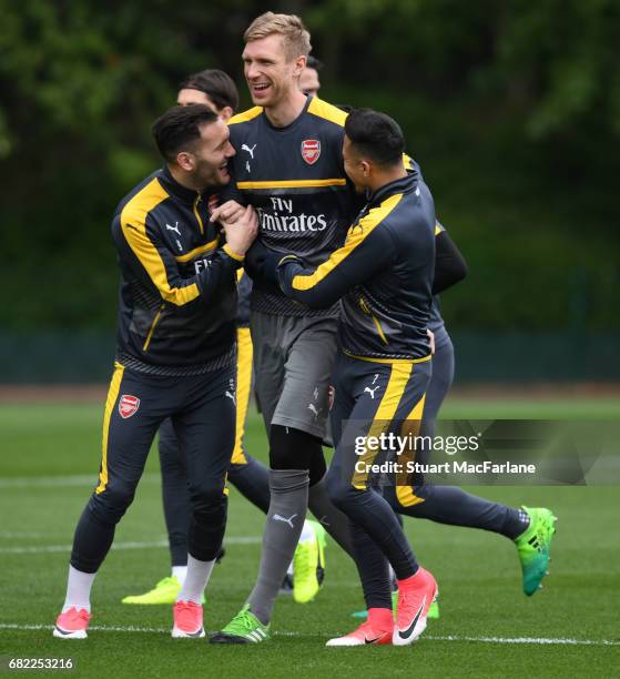 Lucas Perez, Per Mertesacker and Alexis Sanchez of Arsenal during a training session at London Colney on May 12, 2017 in St Albans, England.