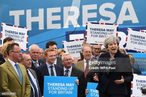 United Kingdom Prime Minister, Theresa May, speaks to party supporters in front of the Conservative party's general election campaign "battle bus" at...