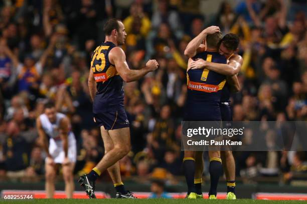 Shannon Hurn, Sam Mitchell and Luke Shuey of the Eagles celebrate winning the round eight AFL match between the West Coast Eagles and the Western...