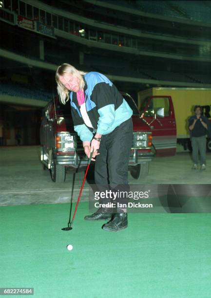Rick Wakeman, backstage practising golf putting on tour with re-formed Yes, Canada, April 1991.