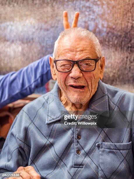 goofy grandpa winking eye funny face with rabbit ears - grandfather face stock pictures, royalty-free photos & images