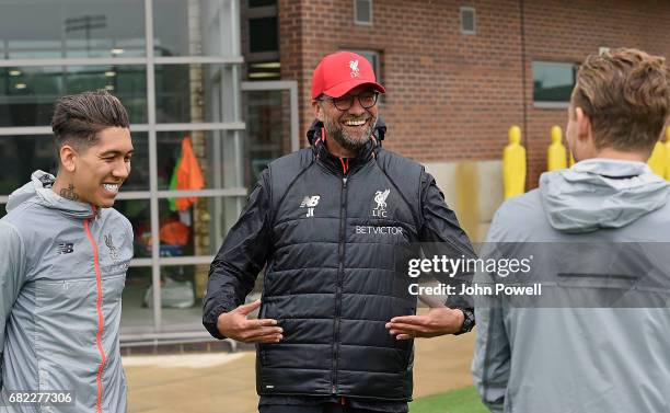 Jurgen Klopp manager of Liverpool with Roberto Firmino and Lucas Leiva during a training session at Melwood Training Ground on May 12, 2017 in...