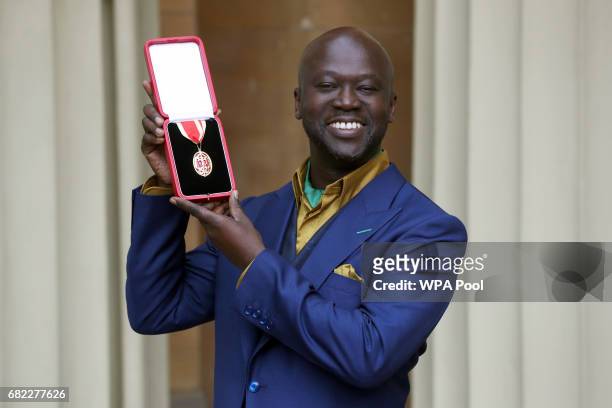 Sir David Adjaye poses after he was Knighted by the Duke of Cambridge during an Investiture ceremony at Buckingham Palace on May 12, 2017 in London,...
