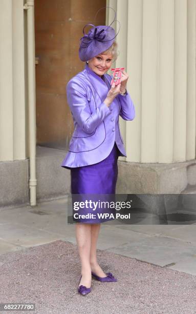 Angela Rippon poses after she was awarded a CBE by the Duke of Cambridge during an Investiture ceremony at Buckingham Palace on May 12, 2017 in...
