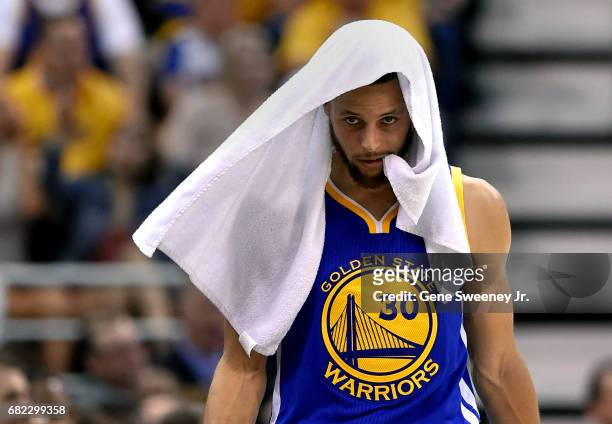Stephen Curry of the Golden State Warriors looks on, walking the sideline against the Utah Jazz in Game Three of the Western Conference Semifinals...