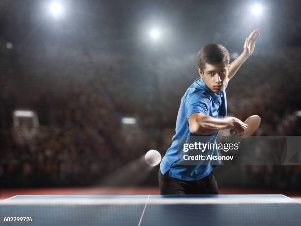 young ping pong player playing table tennis game - table tennis stock pictures, royalty-free photos & images