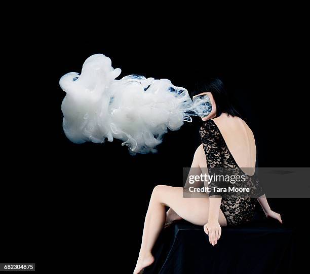 woman with smoke coming our of face - lace bodysuit stock pictures, royalty-free photos & images