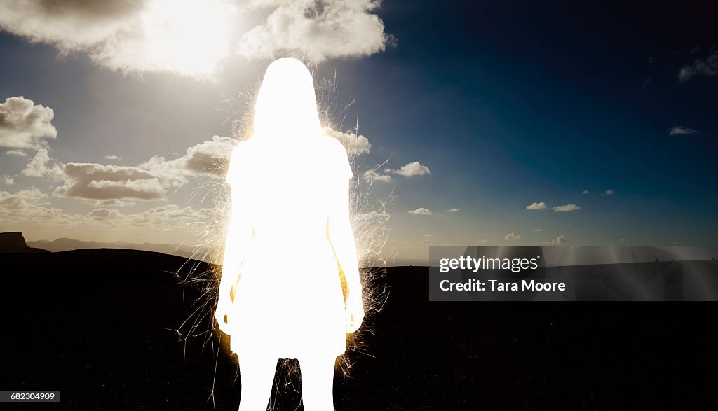 Silhouette of electric woman in nature