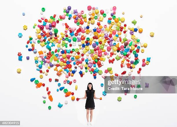 woman throwing colourful beads up - colorsurgetrend imagens e fotografias de stock