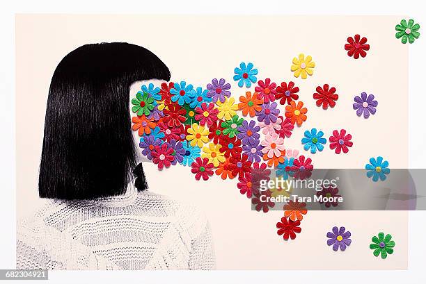 woman with flowers covering face - colorsurgetrend imagens e fotografias de stock