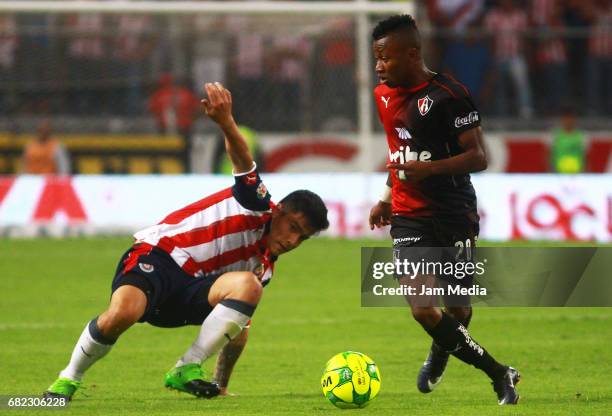 Michael Perez of Chivas and Clifford Aboagye of Atlas compete for the ball during the final Quarters round match between Atlas and Chivas as part of...