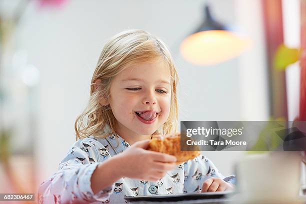 young girl eating breakfast - children eating breakfast stock pictures, royalty-free photos & images