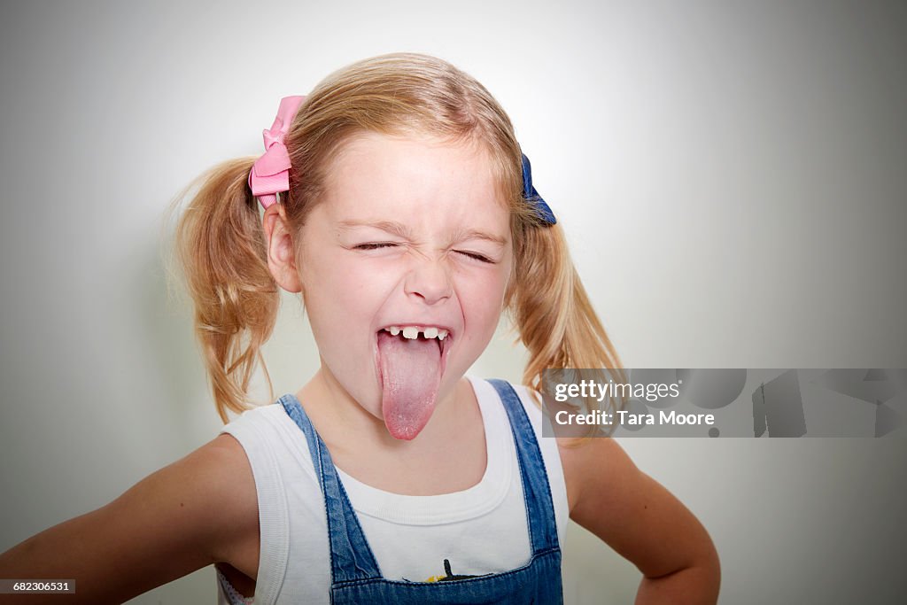 Young girl sticking out tongue