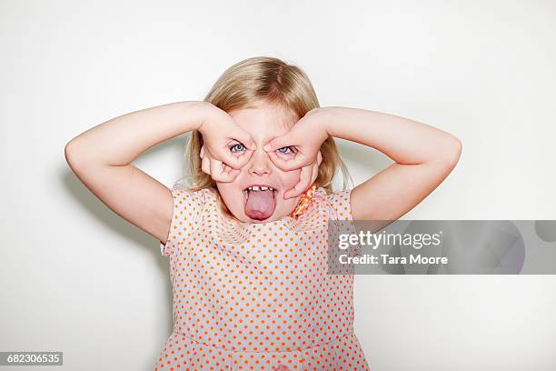 young girl making silly face - making a face stock-fotos und bilder