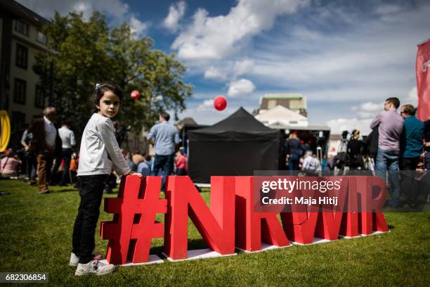 Girl stands next to SPD logo near the stage at the final SPD campaign rally in state elections in North Rhine-Westphalia on May 12, 2017 in Duisburg,...