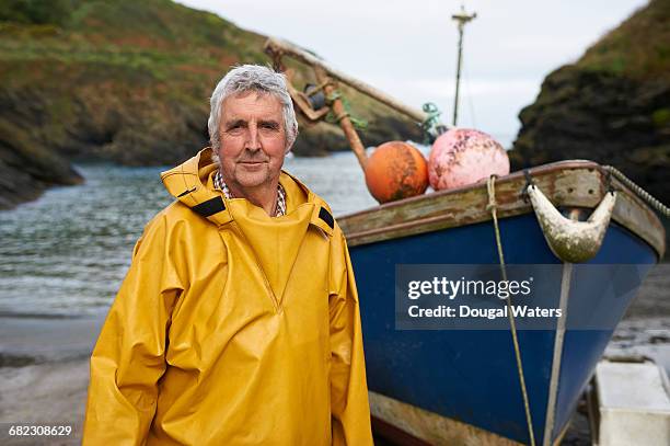 portrait of fisherman and boat on sea shore. - senior hobbies stock pictures, royalty-free photos & images