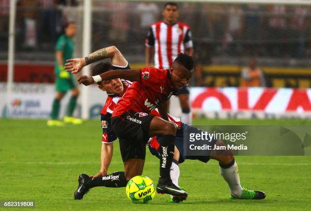 Michael Perez of Chivas and Clifford Aboagye of Atlas fight for the ball during the quarter finals first leg match between Atlas and Chivas as part...