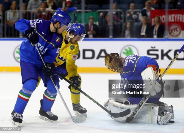 Dennis Everbrg of Sweden fails to score over Frederic Cloutier, goaltender of Italy for the puck during the 2017 IIHF Ice Hockey World Championship...