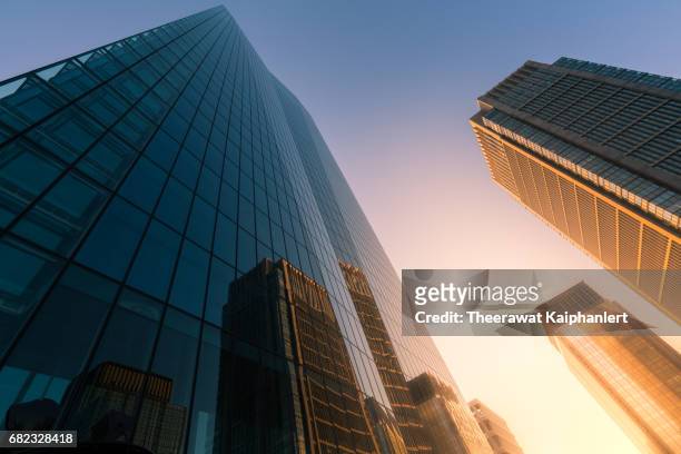 low angle view of skyscrapers in tokyo downtown - financial building stockfoto's en -beelden