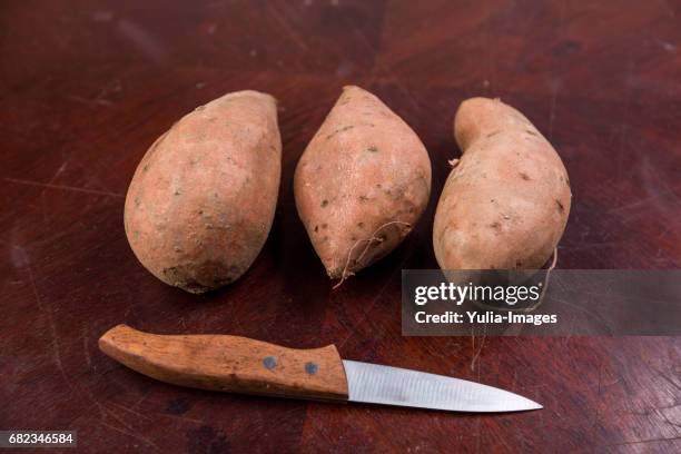 three sweet potatoes - yam stock-fotos und bilder