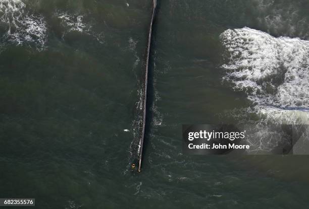 The U.S.-Mexico border fence, seen from above, stretches into the Pacific Ocean on May 11, 2017 in San Diego, California. The fence separates San...