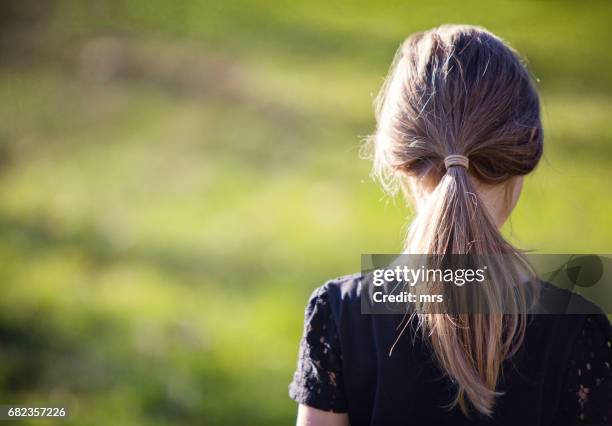 rear view of girl outdoors - children only ponytail stock-fotos und bilder