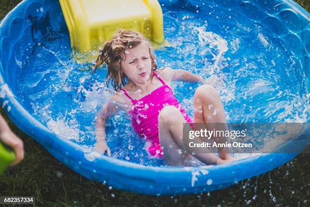 girl splashing into kiddy pool - annie sprinkle stock pictures, royalty-free photos & images