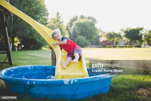 Boy Going Down Slide