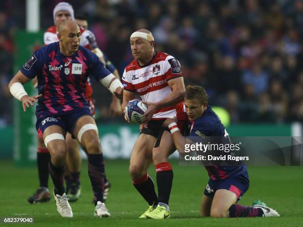 Willi Heinz of Gloucester is tackled by Jules Plisson of Stade Francais during the European Rugby Challenge Cup Final between Gloucester and Stade...