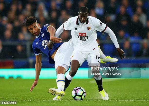 Mason Holgate of Everton attempts to tackle Abdoulaye Doucoure of Watford during the Premier League match between Everton and Watford at Goodison...