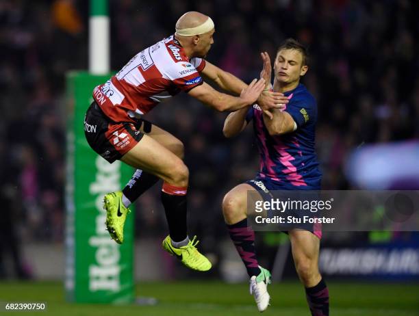 Jules Plisson of Stade Francais is hit with a high tackle from Willi Heinz of Gloucester during the European Rugby Challenge Cup Final between...