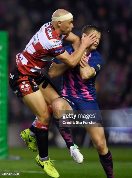 Jules Plisson of Stade Francais is hit with a high tackle from Willi Heinz of Gloucester during the European Rugby Challenge Cup Final between...