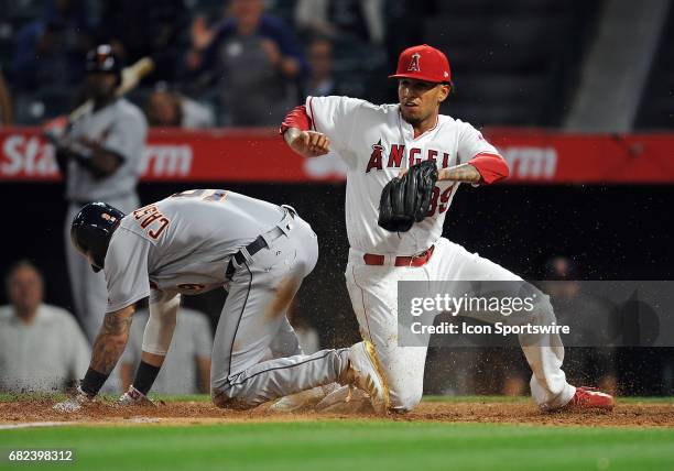 Los Angeles Angels of Anaheim pitcher Keynan Middleton tags Detroit Tigers runner Nicholas Castellanos out at the plate during the ninth inning of a...