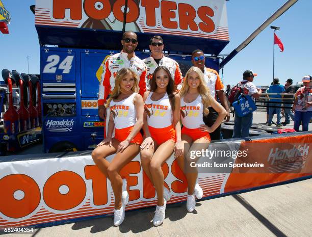 The Hooters girls pose with some of the team crew members prior to the Monster Energy NASCAR Cup Series race on May 7, 2017 at Talladega...