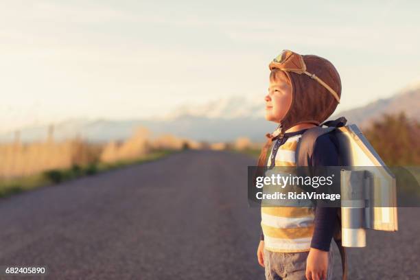 young boy with jet pack dreams of flying - flying goggles stock pictures, royalty-free photos & images