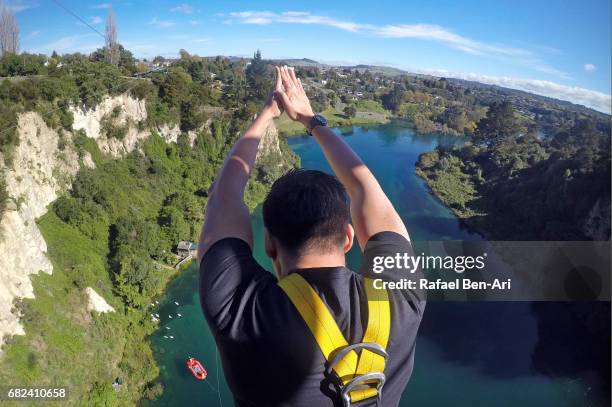 young man bungy jumps in taupo new zealand - north island new zealand fotografías e imágenes de stock